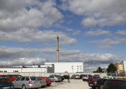 Man walks at the parking lot of the PBS factory in in Velka Bites, Czech Republic, Thursday, Sept. 19, 2019. Small engines built by Czech firm PBS Aerospace are believed to have been used in an attack last weekend that targeted the heart of Saudi Arabia's oil industry. (AP Photo/Petr David Josek)