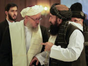 Abdul Salam Hanafi, a deputy prime minister in the Taliban's interim government, left, speaks with acting Foreign Minister of Afghanistan, Taliban official Amir Khan Muttaqi during talks involving Afghan representatives in Moscow, Russia, Wednesday, Oct. 20, 2021. Russia hosted talks on Afghanistan on Wednesday involving senior representatives of the Taliban and neighboring nations, a round of diplomacy that underlines Moscow's clout. Russian Foreign Minister Sergey Lavrov opened the talks and emphasized that "forming a really inclusive government fully reflecting the interests of not only all ethnic groups but all political forces of the country" is necessary to achieve a stable peace in Afghanistan. (AP Photo/Alexander Zemlianichenko, Pool)