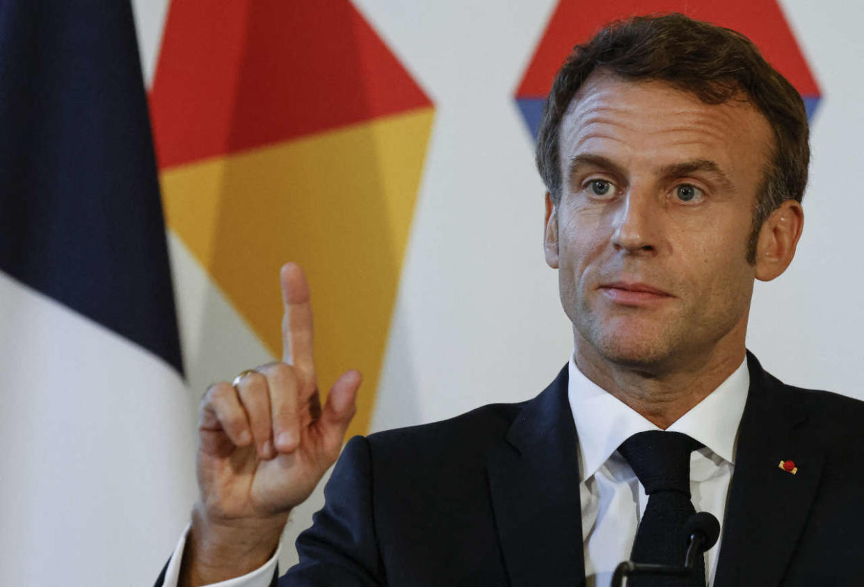 French President Emmanuel Macron gestures as he attends the final press conference at the Prague castle where the European Summit 