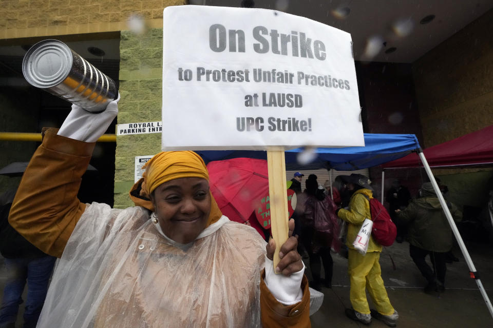 Teacher Sarah Harris joins Los Angeles Unified School District, LAUSD teachers and Service Employees International Union 99 (SEIU) members striking as rain falls outside the Edward R. Roybal Learning Center in Los Angeles Tuesday, March 21, 2023. Tens of thousands of workers in the Los Angeles Unified School District walked off the job Tuesday over stalled contract talks, and they were joined by teachers in a three-day strike that shut down the nation’s second-largest school system. (AP Photo/Damian Dovarganes)