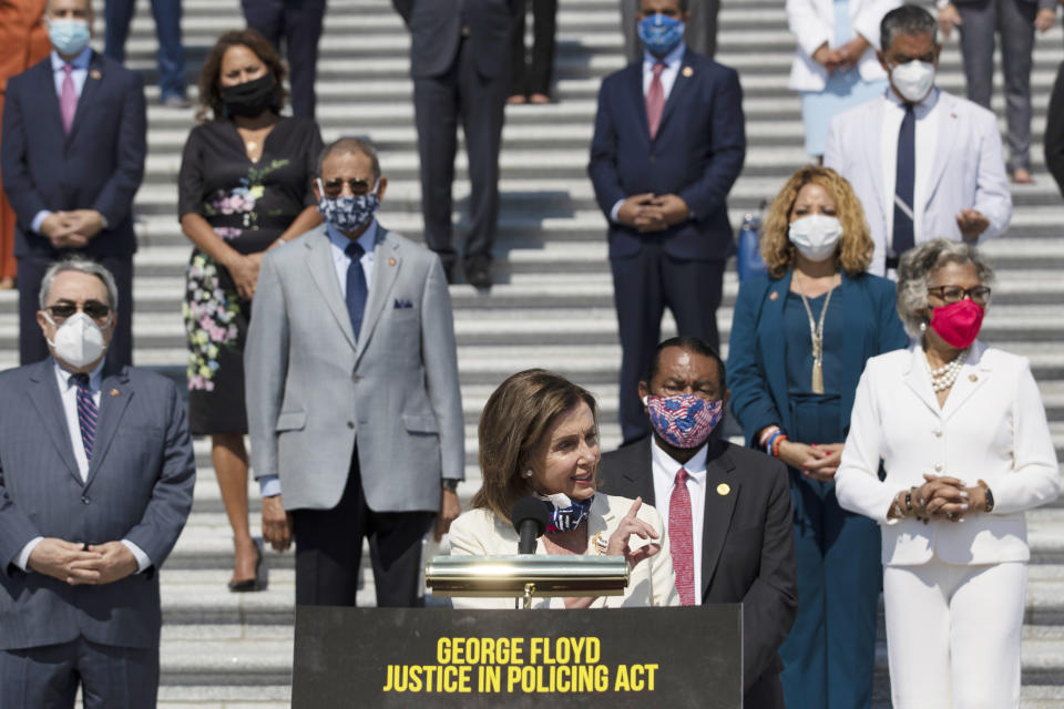 House Speaker Nancy Pelosi of Calif., joined by House Democrats spaced for social distancing, speaks during a news conference on the House East Front Steps on Capitol Hill in Washington, Thursday, June 25, 2020, ahead of the House vote on the George Floyd Justice in Policing Act of 2020. (AP Photo/Carolyn Kaster)