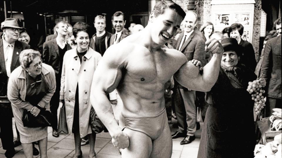 Arnold flexing for fans