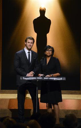 Actor Chris Hemsworth (L) and Academy of Motion Picture Arts and Sciences President Cheryl Boone Isaacs announce the nominees for the 86th Academy Awards in Beverly Hills, California January 16, 2014. REUTERS/Phil McCarten