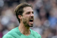 Frankfurt's goalkeeper Kevin Trapp reacts during the German Bundesliga Soccer match between Eintracht Frankfurt and Bayer Leverkusen in Frankfurt, Germany, Sunday, May 5, 2024. Left Leverkusen's Granit Xhaka who scored the first goal. (AP Photo/Michael Probst)