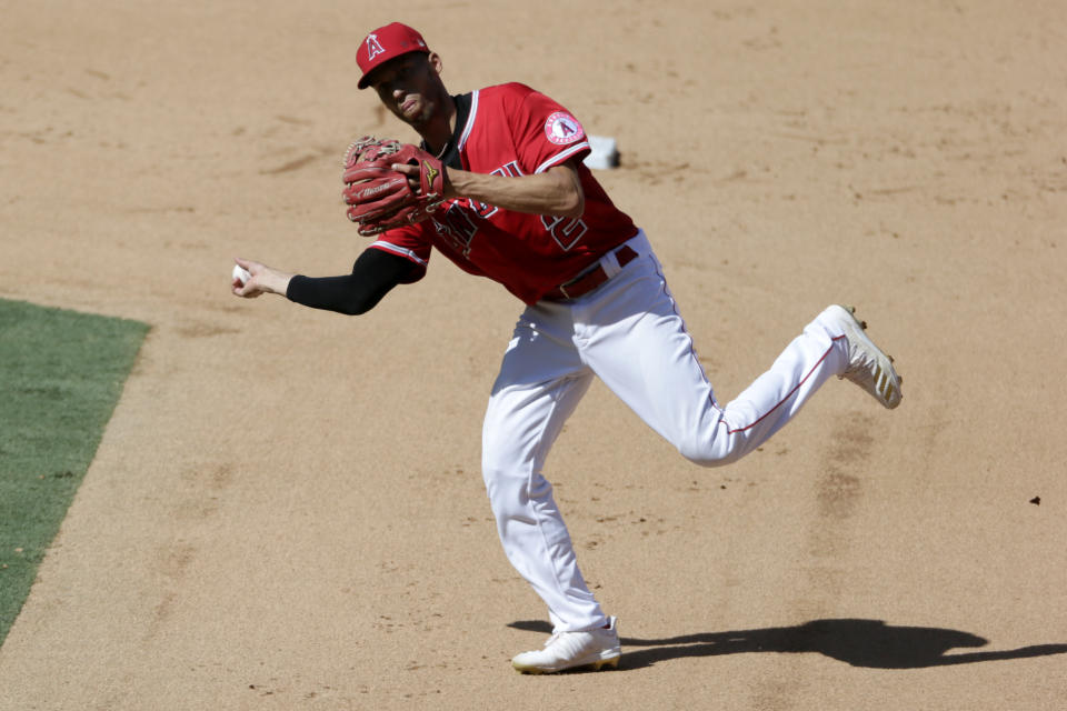 Los Angeles Angels shortstop Andrelton Simmons throws to first to get Texas Rangers' Rougned Odor out on a ground ball during the sixth inning of a baseball game in Anaheim, Calif., Sunday, Sept. 20, 2020. (AP Photo/Alex Gallardo)