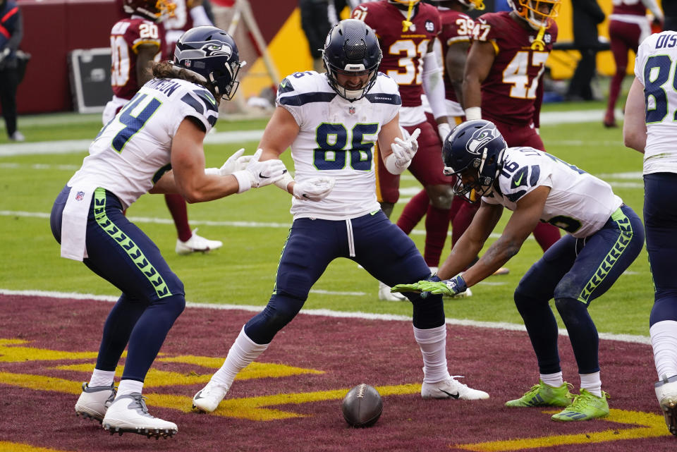 Seattle Seahawks tight end Jacob Hollister (86) celebrating his touchdown with teammates tight end Colby Parkinson (84) and wide receiver Tyler Lockett (16) during the first half of an NFL football game against the Washington Football Team, Sunday, Dec. 20, 2020, in Landover, Md. (AP Photo/Andrew Harnik)