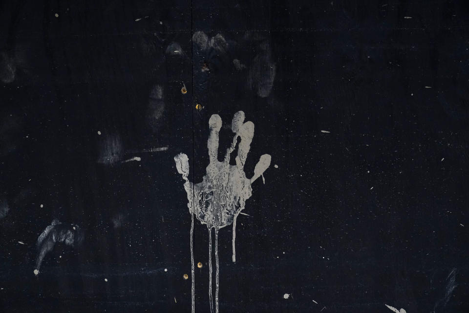 A mud hand print is seen on a wall on Friday, Aug. 5, 2022, in Fleming-Neon, Ky. (AP Photo/Brynn Anderson)