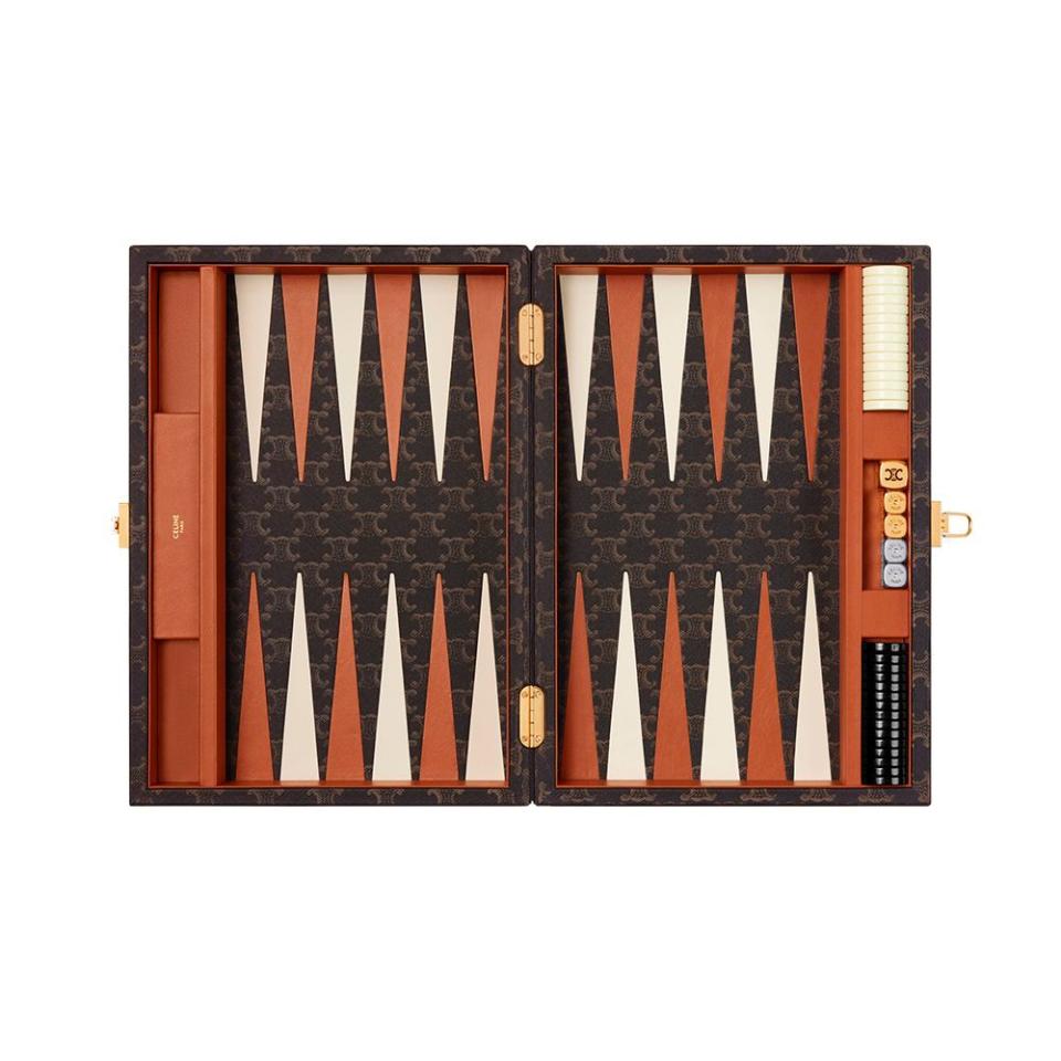 <p><a href="https://www.celine.com/en-us/celine-shop-women/celine-maison-collection/maison-and-travel-accessories/backgammon-in-triomphe-canvas-4M2442AKW.04BT.html" rel="nofollow noopener" target="_blank" data-ylk="slk:Shop Now;elm:context_link;itc:0;sec:content-canvas" class="link ">Shop Now</a></p><p>Backgammon in Triomphe Canvas</p><p>celine.com</p>