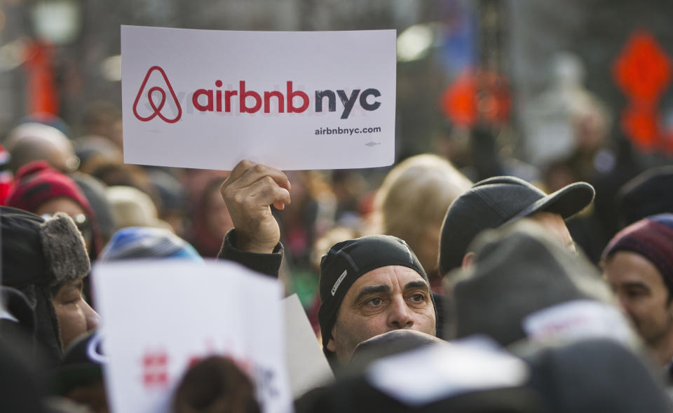 FILE - In this Jan. 20, 2015, file photo, supporters of Airbnb hold a rally outside City Hall in New York. Airbnb faces tightening regulations in New York City that could take a big bite out of its profits, and on Wednesday, Aug. 15, 2018, the short-term rental company offered a counter-measure designed to appease hostile politicians: a $10 million contribution to charities. (AP Photo/Bebeto Matthews, File)