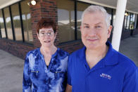 Charleen Ferguson, left, poses for a photo with her husband Jay Ferguson in front of the building they own in Wylie, Texas, Friday, July 1, 2022. Landlords were forgiving about rent during the first two years of the pandemic, but now many are asking for back due rent. The Fergusons own the building that houses the tech business they own, Just Call the I.T. Guy and also have 13 tenants, so they see the dilemma from both the small business and landlord points of view. (AP Photo/LM Otero)