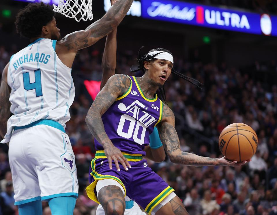 Utah Jazz guard Jordan Clarkson (00) passes around Charlotte Hornets center Nick Richards (4) in Salt Lake City on Thursday, Feb. 22, 2024. The Hornets won 115-107. | Jeffrey D. Allred, Deseret News