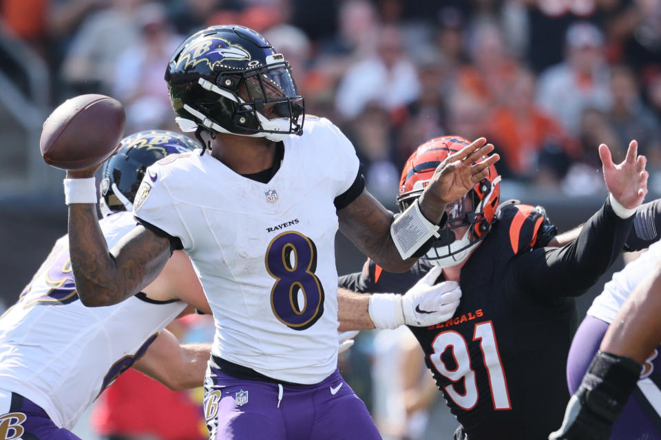 Lamar Jackson got the last laugh with four TD passes in an overtime win against the division rival Bengals. (Photo by Andy Lyons/Getty Images)