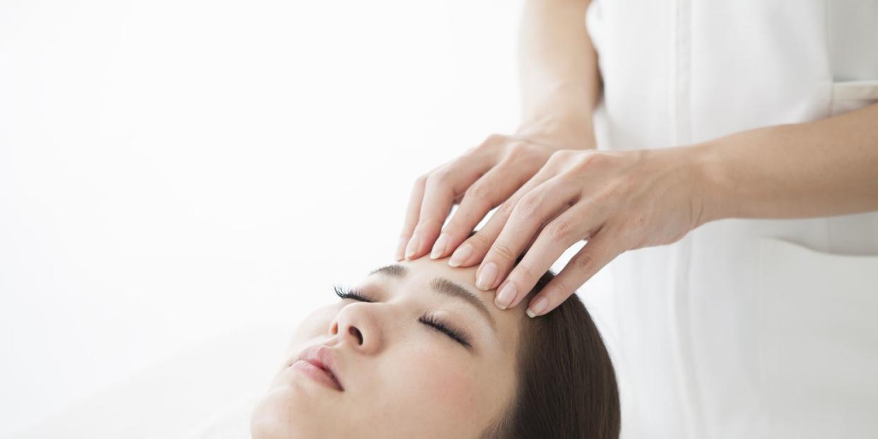 woman being massaged by a salon with her forehead