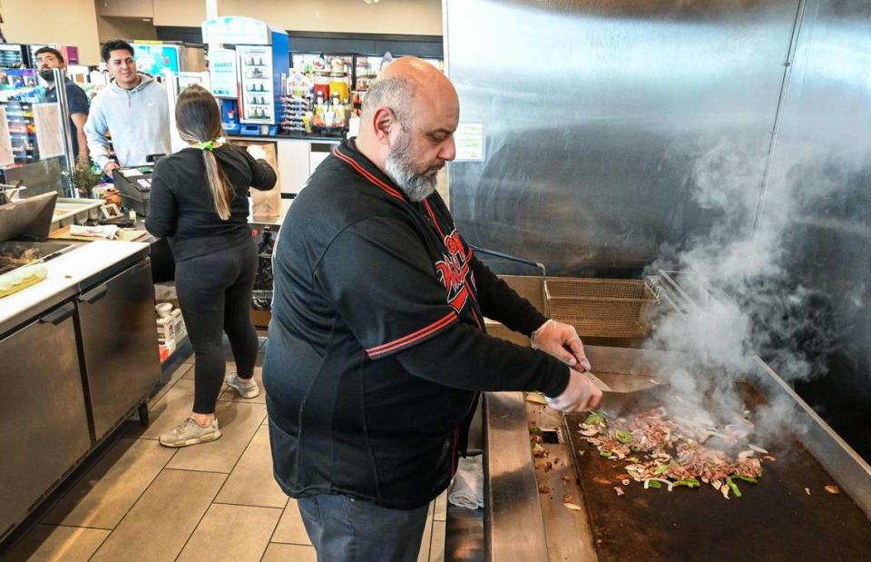 Wilson Tadros, who owns the Willy’s Phillys local Philly cheesesteak sandwich company, prepares one of his Willy’s Way originals Philly cheesesteaks at his new location in the 76 gas station at Herndon and and Van Buren Avenue near the Marketplace at El Paseo in northwest Fresno on Friday, May 31, 2023.