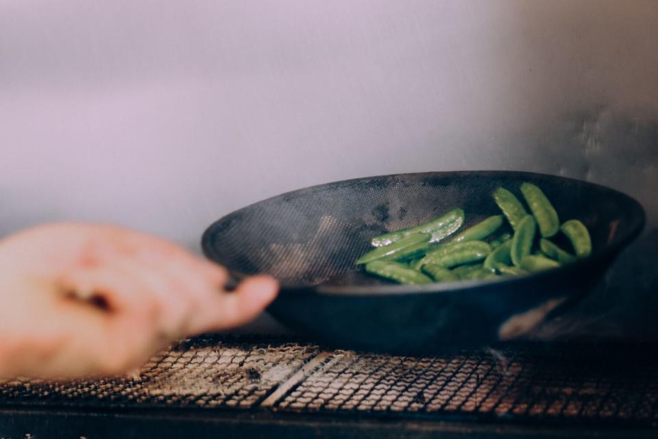 Chef and owner Doug Rankin prepares the Snap Peas dish at Bar Chelou.