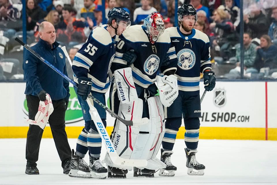 Apr 4, 2024; Columbus, Ohio, USA; Columbus Blue Jackets goaltender Daniil Tarasov (40) is helped off the ice by defenseman David Jiricek (55) and left wing Alexander Nylander (92) during the first period of the NHL hockey game against the New York Islanders at Nationwide Arena.