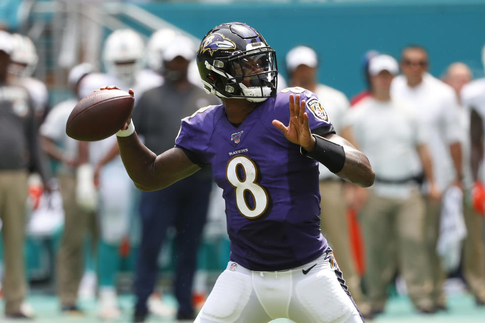 FILE - In this Sept. 8, 2019, file photo, Baltimore Ravens quarterback Lamar Jackson (8) looks to pass the ball during the first half at an NFL football game against the Miami Dolphins, in Miami Gardens, Fla. The Baltimore Ravens are really looking forward to seeing Terrell Suggs this Sunday _ right up until the opening kickoff of their game against the Arizona Cardinals. At the point, the Ravens will turn their attention toward keeping their former teammate clear of quarterback Lamar Jackson.(AP Photo/Wilfredo Lee, File)