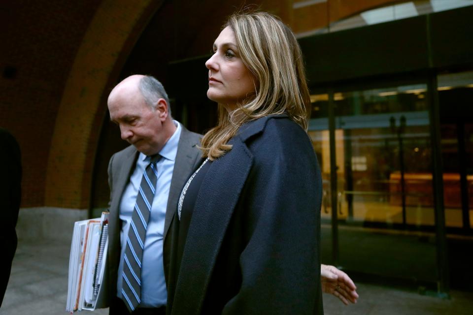 Michelle Janavs stands with attorney Thomas Bienert outside federal court, Tuesday, Feb. 25, 2020, in Boston, after she was sentenced to five months in prison for trying to cheat and bribe her daughters' way into college as part of a nationwide college cheating scam.