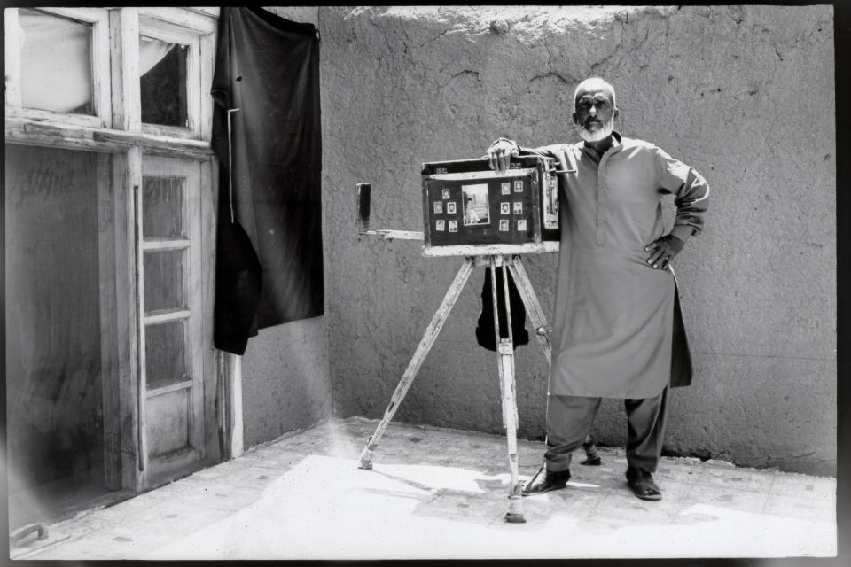 Street photographer Lutfullah Habibzadeh, 72, poses for a portrait at his house on the outskirts of Kabul, Afghanistan, Monday, May 29, 2023. (AP Photo/Rodrigo Abd)