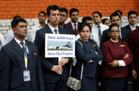 A Jet Airways employee holds a placard as he and others attend a protest demanding to "save Jet Airways" in New Delhi, India, April 18, 2019. REUTERS/Adnan Abidi