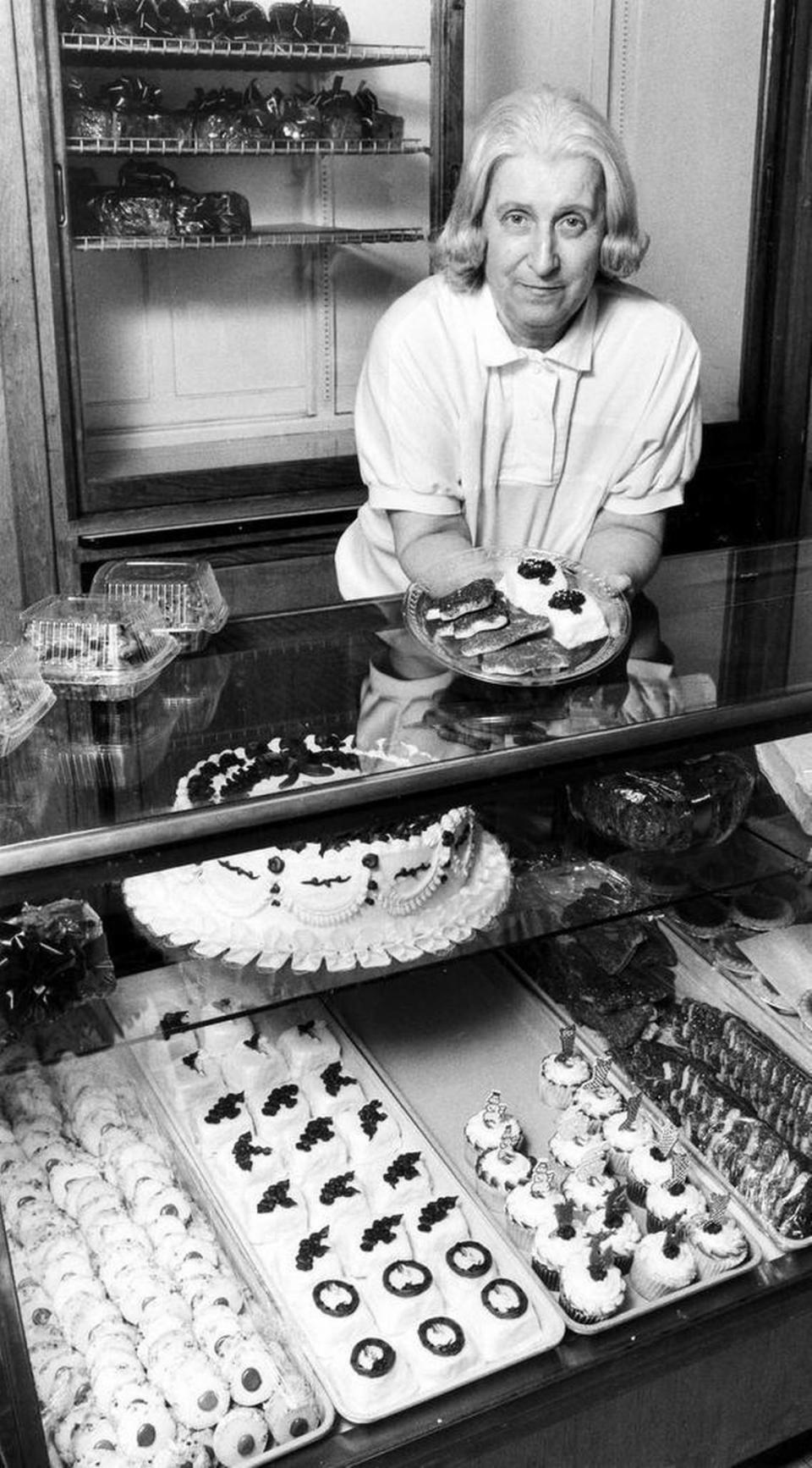 Joyce Higgins, owner of Magee’s Bakery with her husband, Ralph, displays some Christmas cookies and petit fours. Dec. 6, 1990 that are being baked now for the holidays. Her cases are filled with many other homemade treats.