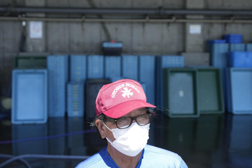 Hideaki Igari, fish market middleman, speaks with the Associated Press at Numanouchi port, Iwaki, northeastern Japan, near the Fukushima Daiichi nuclear power plant, damaged by a massive March 11, 2011, earthquake and tsunami, on Friday, Aug. 25, 2023. Igari said prices for flounder, among Fukushima's signature fish known as Joban-mono, was about 10% lower on Friday at a morning auction, first since the Fukushima Daiichi started releasing treated and diluted radioactive wastewater into the Pacific Ocean on Thursday. (AP Photo/Eugene Hoshiko)