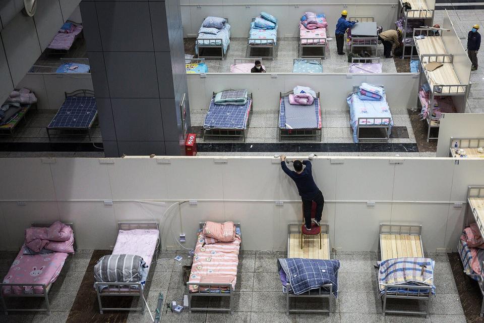 Workers prepare beds at Wuhan International Conference and Exhibition Center in Wuhan, China, the city believed to be at the center of the outbreak.