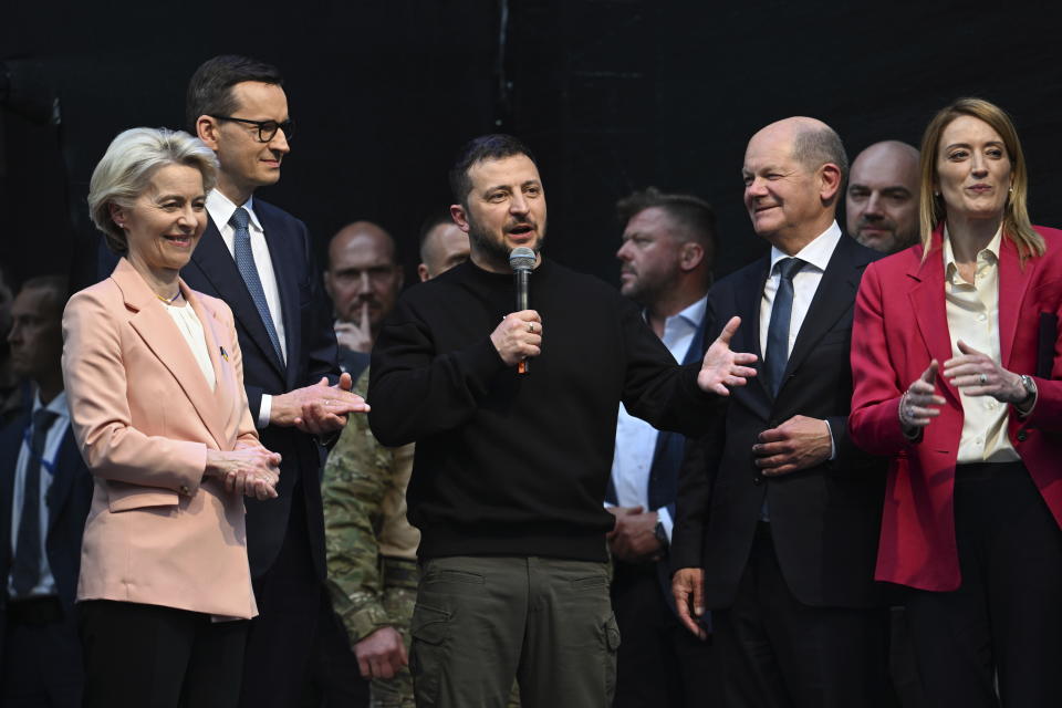 Ukrainian President Volodymyr Zelenskyy, center, talks to the crowd after the award ceremony of the Charlemagne Prize in Aachen, Germany, Sunday, May 14, 2023. Zelenskyy is in Aachen to receive the International Charlemagne Prize, awarded to him and the people of Ukraine and is surrounded by, front from left, Ursula von der Leyen, President of the EU Commission, the Prime Minister of Poland Mateusz Morawiecki, German Chancellor Olaf Scholz and Roberta Metsola, President of the EU Parliament. (Federico Gambarini/DPA via AP, Pool)