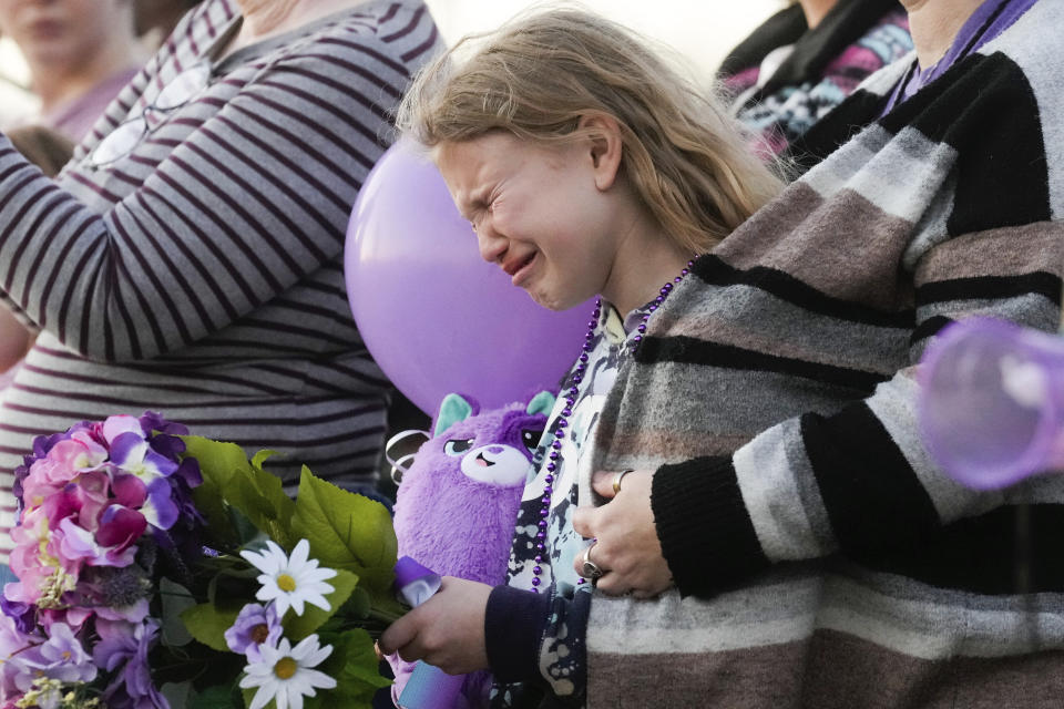 FILE - Kristlyn Wood, a cousin of 11-year-old Audrii Cunningham, reacts during a vigil in Cunningham's honor, Wednesday, Feb. 21, 2024, in Livingston, Texas. As mourners prepare for the funeral of 11-year-old Audrii Cunningham, who was killed near Houston, the community wants answers about how the suspect in her death was allowed to remain free despite a long criminal history of violence. (Jason Fochtman/Houston Chronicle via AP, File)