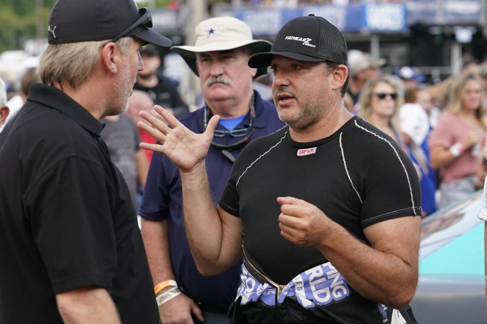 FILE - Tony Stewart, right, talks before an SRX Series auto race in Nashville, Tenn., July 17, 2021. Hall of Famer Stewart will return to full-time competition this season — as an NHRA drag racer. The three-time NASCAR champion will run a Top Alcohol dragster for McPhillips Racing for the full 2023 NHRA season. (AP Photo/Mark Humphrey, File)