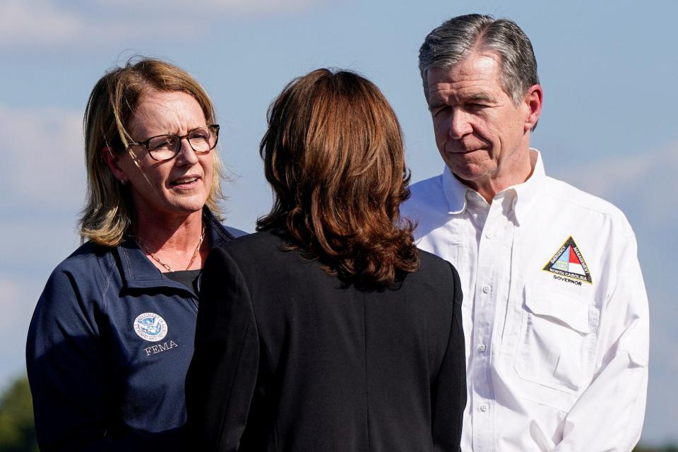 Vice President Kamala Harris, the Democratic presidential nominee, is welcomed by North Carolina Gov. Roy Cooper and Deanne Criswell, administrator of the U.S. Federal Emergency Management Agency, at Charlotte Douglas International Airport on Saturday.