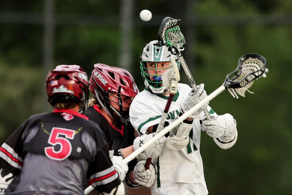 Olympus’ Edison Cutler, passes the ball over the head of Northridges’ Blake Jonas as they play in semifinal lacrosse action at Westminster in Salt Lake City on Wednesday, May 24, 2023. | Scott G Winterton, Deseret News