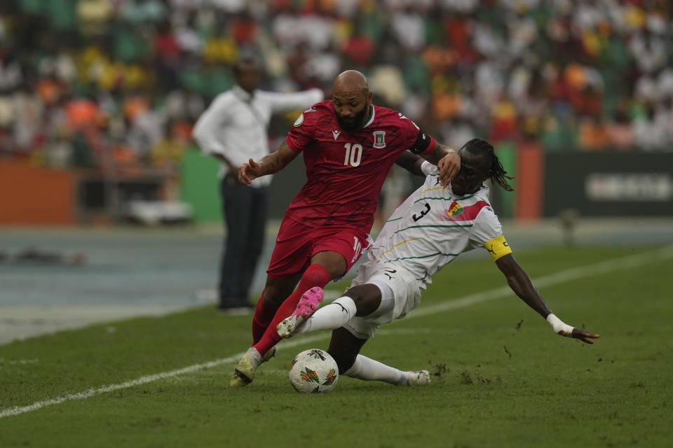 Guinea's Issiaga Sylla, right, challenges Equatorial Guinea's Emilio Nsue, during the African Cup of Nations Round of 16 soccer match between Equatorial Guinea and Guinea, at the Olympic Stadium of Ebimpe in Abidjan, Ivory Coast, Sunday, Jan. 28, 2024. (AP Photo/Themba Hadebe)