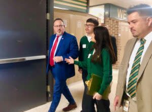 Bryan High students Fatima Davila and Bryan Benitez lead U.S. Education Secretary Miguel Cardona during his visit to Bryan High. On the right is Principal Rony Ortega. (Cindy Gonzalez/Nebraska Examiner)