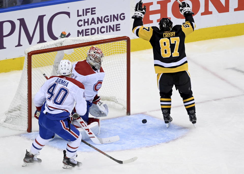 Pittsburgh Penguins center Sidney Crosby (87) celebrates his goal as Montreal Canadiens goaltender Carey Price (31) and teammate Joel Armia (40) look on during the first period of an NHL hockey playoff game Monday, Aug. 3, 2020 in Toronto. (Nathan Denette/The Canadian Press via AP)