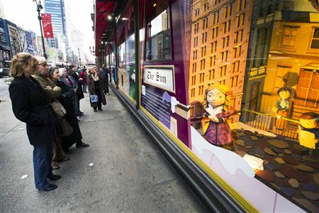 Pedestrians stop to look at holiday window displays at Macy's flagship store in New York, November 22, 2013. REUTERS/Lucas Jackson