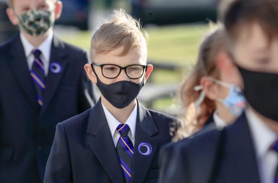 Pupils wearing protective face masks (PA) (PA Archive)