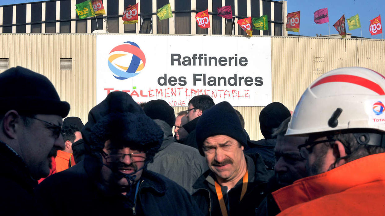 Employees of Oil giant Total gather as they vote to remain on strike at the company's refinery in Fort Mardyck on March 9, 2010. Oil giant Total announced yesterday the closure of its refinery in northern France but vowed to protect jobs by reassigning workers at the strike-hit plant.Total promised not to lay off the 370 workers at the refinery, for whom it plans restructuring measures, including a new fuel depot and training centre, as it winds down its refining operations by 2013. 
AFP PHOTO PHILIPPE HUGUEN (Photo by PHILIPPE HUGUEN / AFP)