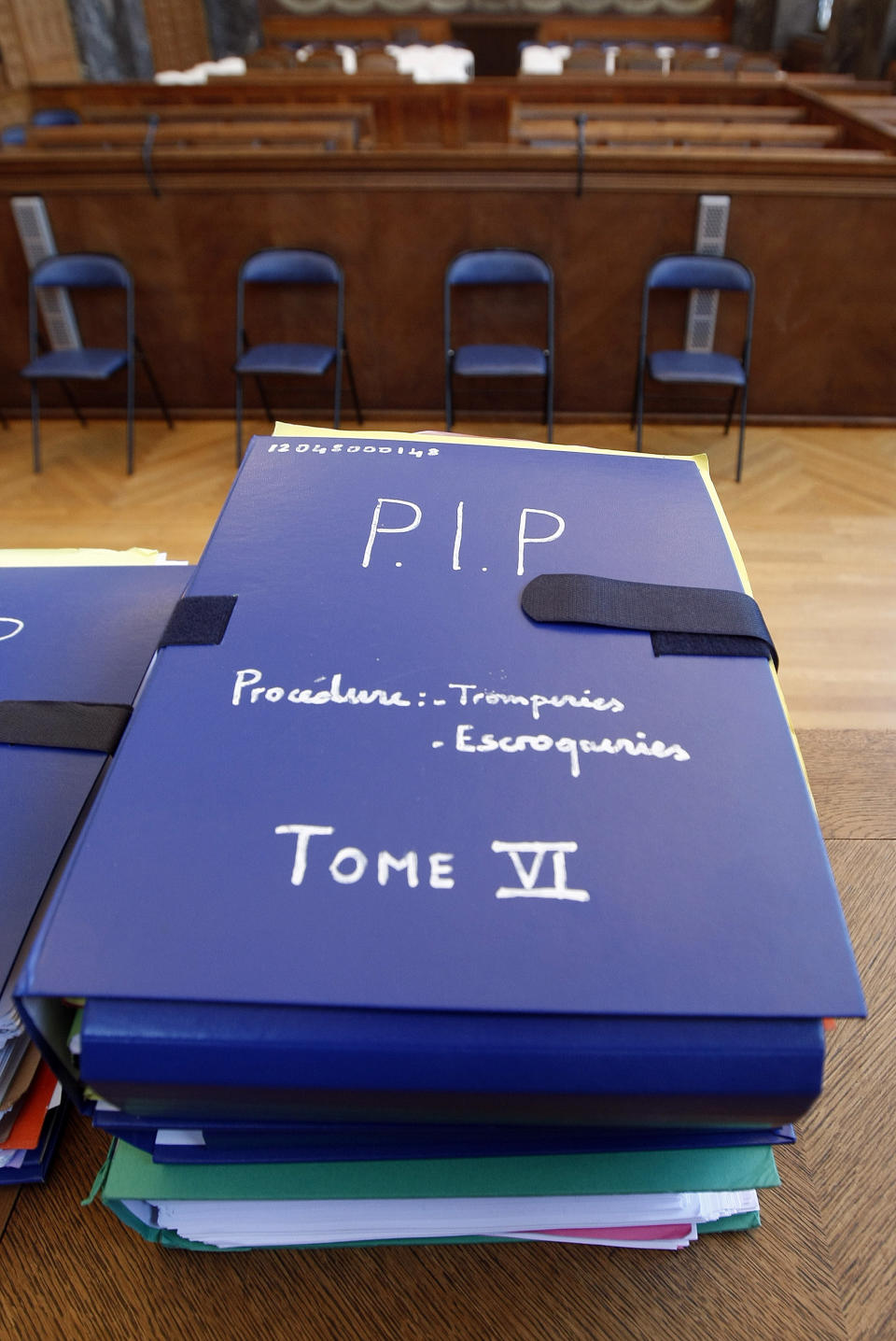 Documents concerning the Poly Implant Prothese (PIP) breast implant trial, are displayed in the courthouse in Marseille, southern France, Monday, Dec. 9, 2013. A court decides Tuesday whether Jean-Claude Mas, founder of the defunct PIP silicone breast implant company, is guilty of aggravated fraud by making tens of thousands of defective implants using industrial grade silicone, and selling them worldwide. The tribunal is expected to decide whether the German product-testing firm TUeV Rheinland was a victim of deception by Jean-Claude Mas or could be held responsible by failing to properly check the implants. More than 125,000 women received the implants until sales ended in March 2010. (AP Photo/Claude Paris)