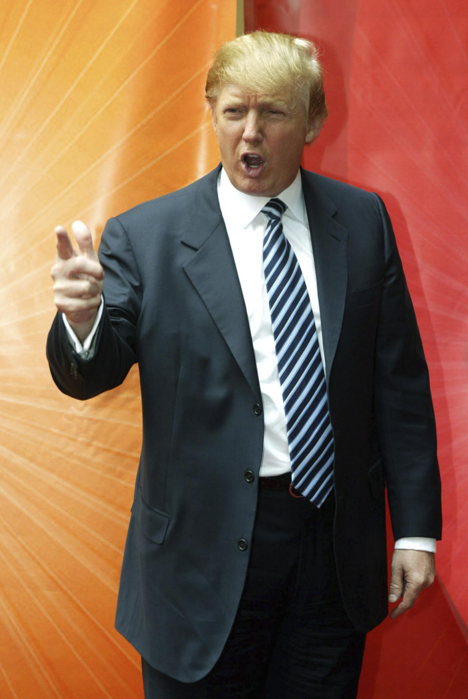 FILE - Mogul Donald Trump, who stars in NBC's "The Apprentice," strikes his classic "You're fired" pose as he arrives at Radio City Music Hall for a presentation of new and returning NBC shows, Monday, May 16, 2005, in New York. A producer's new account of Trump's behavior on "The Apprentice" is resurfacing allegations about whether he mistreated Black people who appeared on the show. (AP Photo/Mary Altaffer, File)