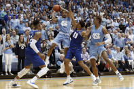 North Carolina guard Christian Keeling looks to pass while forward Armando Bacot, right, defends against Duke forward Javin DeLaurier (12) and forward Wendell Moore Jr. during the first half of an NCAA college basketball game in Chapel Hill, N.C., Saturday, Feb. 8, 2020. (AP Photo/Gerry Broome)