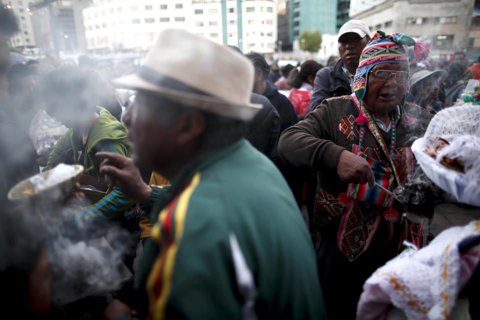 In this picture taken Monday, Jan. 6, 2020, spiritual indigenous guides perform traditional blessings on baby Jesus dolls after parishioners leave the Three Kings Day Mass outside the San Francisco Church in La Paz, Bolivia. During the nearly 14-year presidency of Evo Morales, that recently came to an abrupt and controversial end, Pachamama practices that were celebrated and used in official government events as the nation's first indigenous president de-emphasized the institutional weight the Catholic Church held. (AP Photo/Natacha Pisarenko)