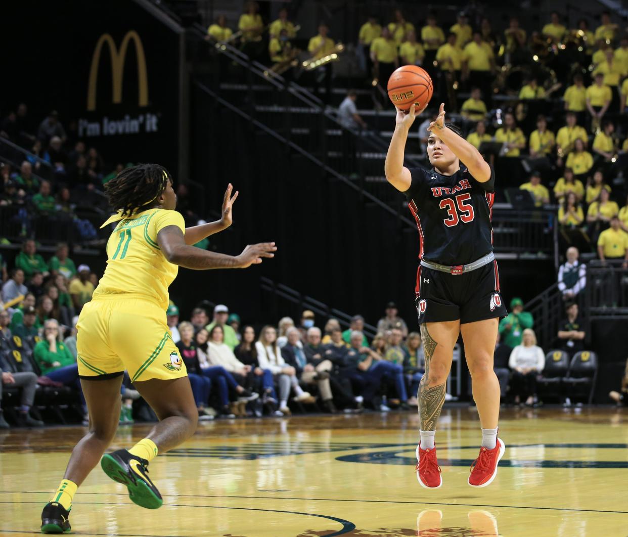 Utah's Alissa Pili, right, shoots over Oregon's Taylor Hosendove during the first half in Eugene Sunday, Feb. 5, 2023.
