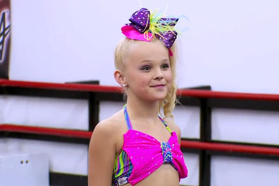 <p>Siwa followed up her debut with a two-season stint on <em>Dance Moms </em>in 2015.</p> <p>Siwa and her mom, Jessalyn, became staples on the show, with Jessalyn saying when the pair were introduced for season 2, "I would say it's my mission in life to make JoJo a star." For her part, Siwa was known for being unafraid to talk back to coach Abby Lee Miller. </p> <p>Siwa told <a href="https://people.com/celebrity/jojo-siwa-five-things-to-know-about-dance-moms-newest-breakout-star/" rel="nofollow noopener" target="_blank" data-ylk="slk:PEOPLE;elm:context_link;itc:0;sec:content-canvas" class="link ">PEOPLE</a> in 2016 of her relationship with Miller, "She's tough, but I love her. She makes me cry a lot, but you kind of just have to grab some tissues and go back in."</p> <p>The show's executive producer, Bryan Stinson, told <em><a href="https://www.rollingstone.com/music/music-features/jojo-siwa-glitter-covered-empire-849071/" rel="nofollow noopener" target="_blank" data-ylk="slk:Rolling Stone;elm:context_link;itc:0;sec:content-canvas" class="link ">Rolling Stone</a>, "</em>During shooting, the crew would gather in the control room to watch JoJo's interviews live because they were so compelling." </p>