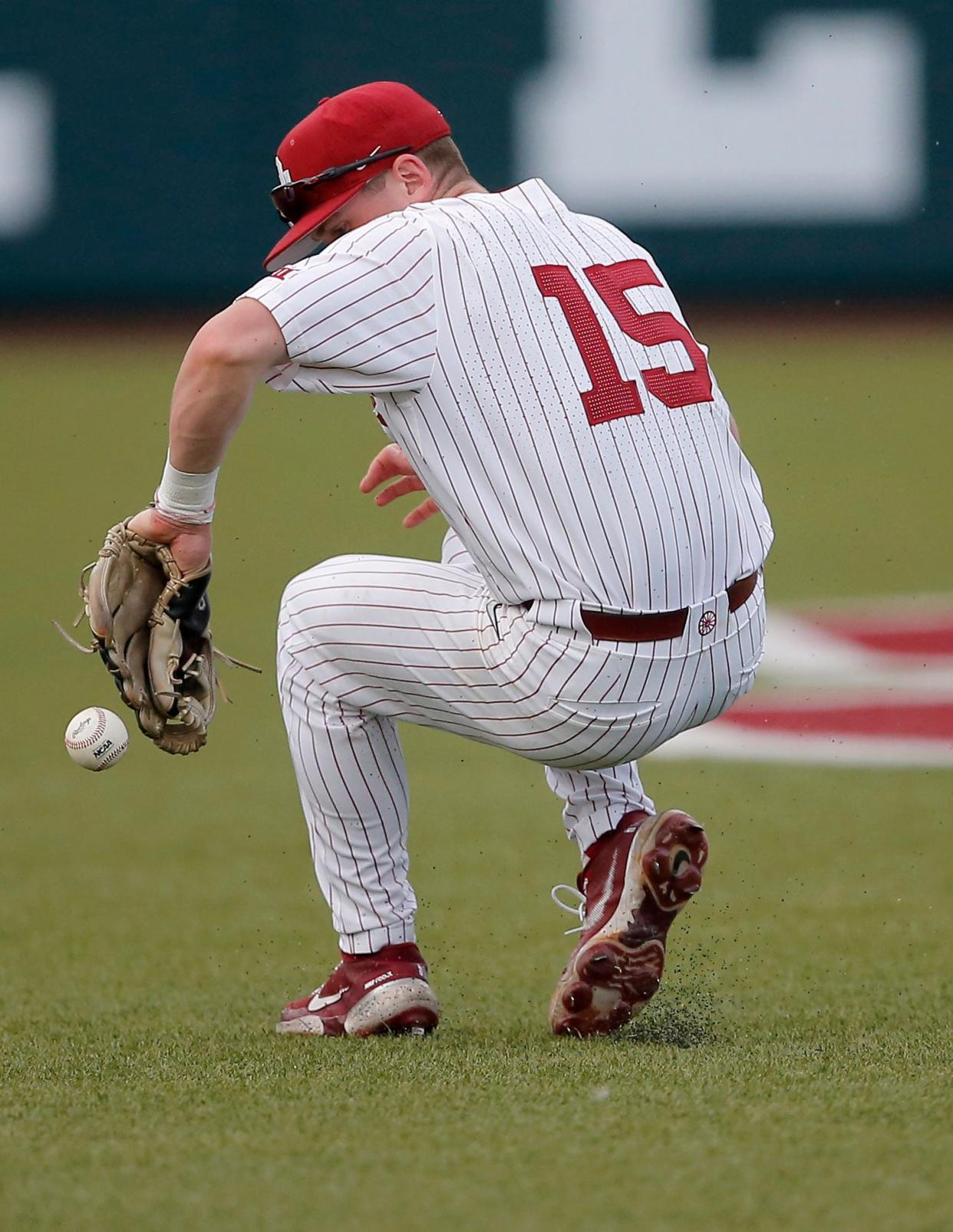 Oklahoma's Jackson Nicklaus (15) tries to field a ground ball during the Bedlam baseball game between the University of Oklahoma Sooners and the Oklahoma State University Cowboys at L. Dale Mitchell Park in Norman, Okla., Thursday, May, 18, 2023. 