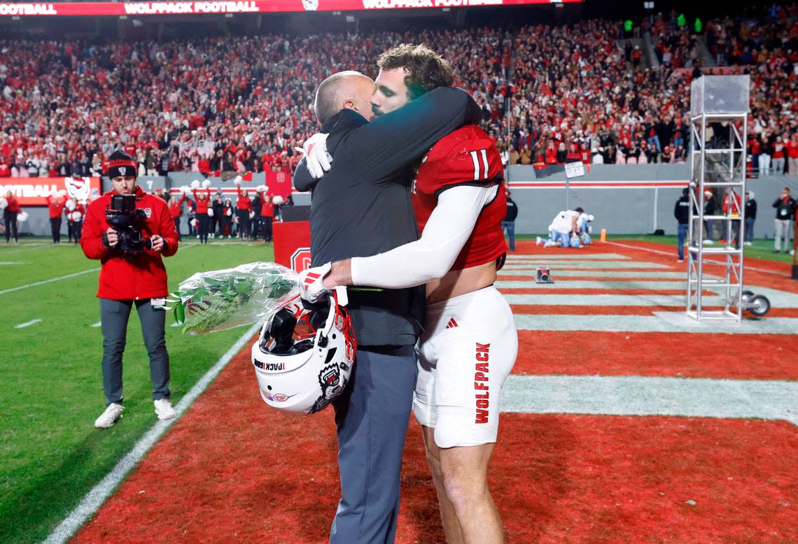 N.C. State head coach Dave Doeren hugs linebacker Payton Wilson (11) as seniors are recognized before N.C. State’s game against UNC at Carter-Finley Stadium in Raleigh, N.C., Saturday, Nov. 25, 2023.