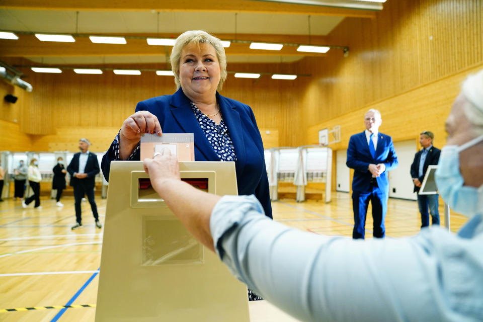 Norway's Prime Minister Erna Solberg, leader of the The Conservative Party Hoyre, casts her ballot in the 2021 parliamentary elections, at Skjold School in Bergen, Norway, Monday, Sept. 13, 2021. Norwegians are heading to the polls on Monday with the ruling Conservatives, led by Prime Minister Erna Solberg, and the opposition Labor Party, which is leading in opinion polls, both advocating for a gradual move away from the use of fossil fuels that continue to underpin the economy. (Hakon Mosvold Larsen/NTB via AP)