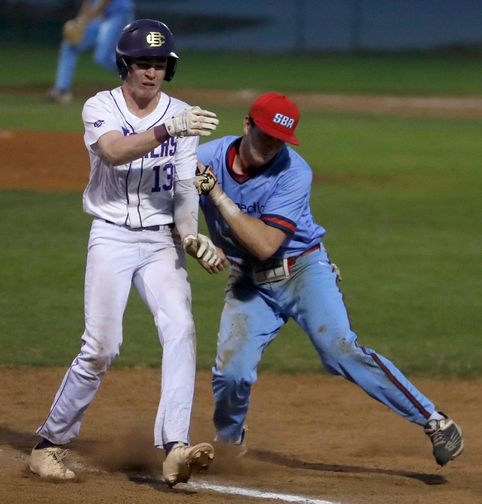 Christian Brothers' Gabe Boyd (13) collides with St. Benedict's Mason McHughes (3) as he arrives at first base during a game Tuesday, April 12, 2022, at Christian Brothers High School. Christian Brothers defeated St. Benedict 22-5.