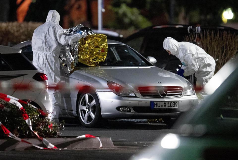 FILE - In this Feb.20, 2020 file photo police forensic officers investigate at the scene after a shooting in central Hanau, Germany. Several people were killed in shootings in the German city of Hanau on Wednesday evening, (AP Photo/Michael Probst,file)