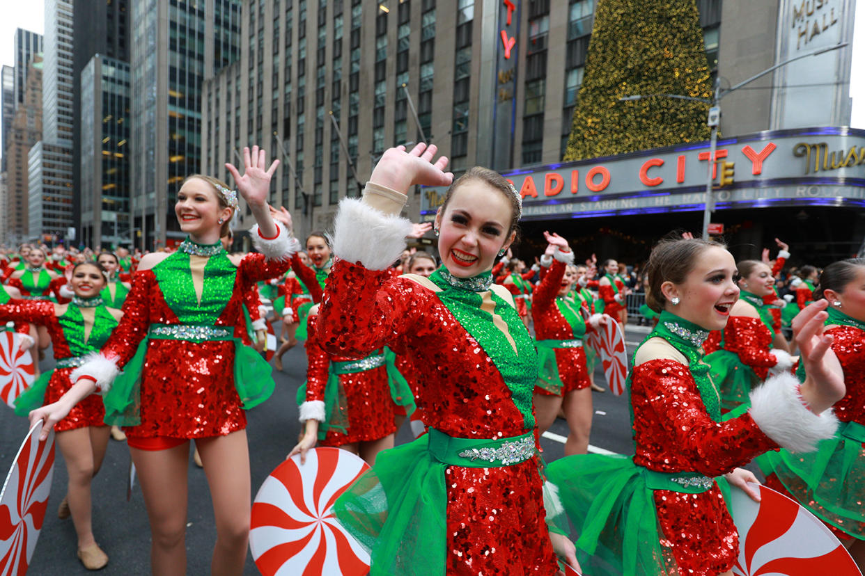 Performers dressed as Santas helpers wave to the crowd in the 93rd Macy’s Thanksgiving Day Parade in New York. (Photo: Gordon Donovan/Yahoo News)